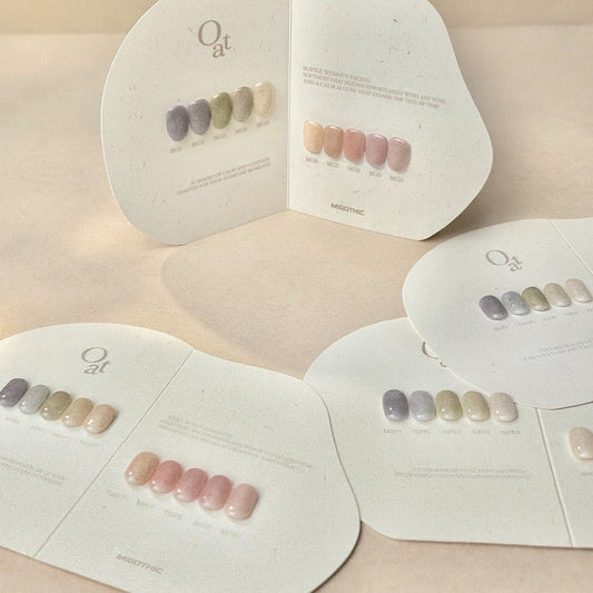 Set of nail polish bottles with a color swatch card on a neutral background