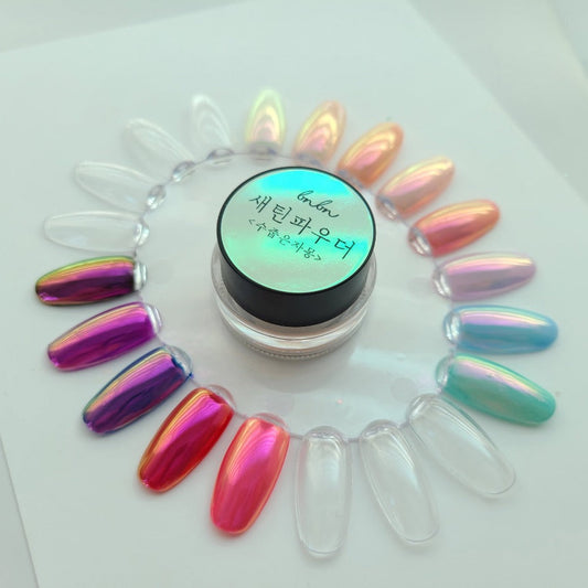 Iridescent nail powder with colorful nails on a white background