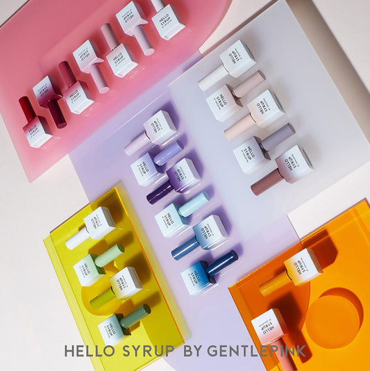 Colorful bottle set with 'HELLO SYRUP BY GENTLE PINK' branding on a pink background.