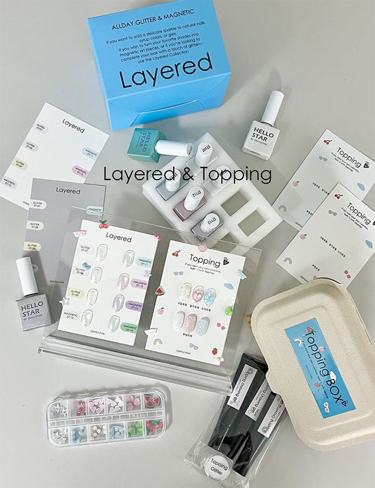 Nail art supplies including nail polish bottles, design sheets, and tools with 'Layered & Topping' branding.