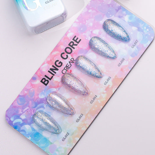 Bling core nail art display with glittery nails on a colorful card
