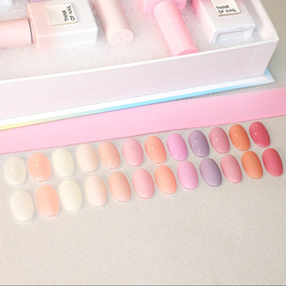 Nail polish collection with pastel shades and packaging on a white background