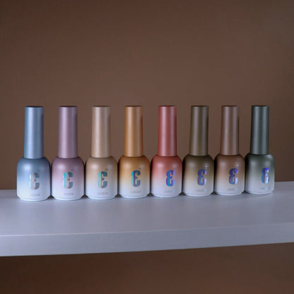 Row of Soozza nail polish bottles on a white surface with a brown background